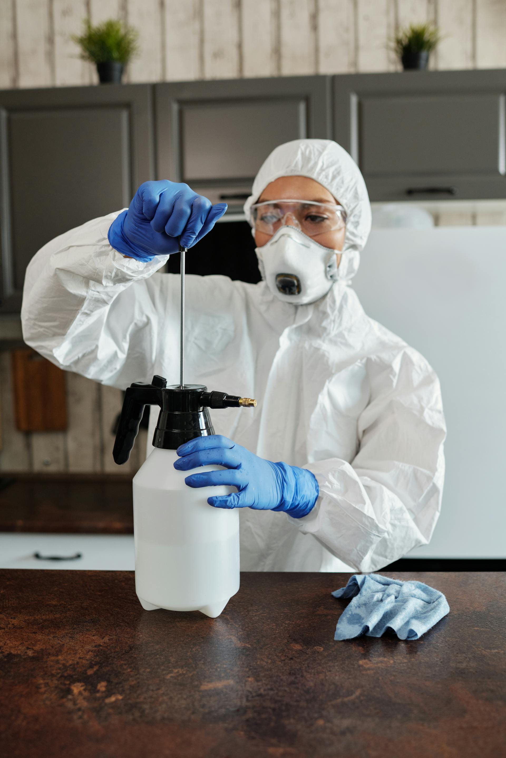 Technician in protective coveralls and respirator