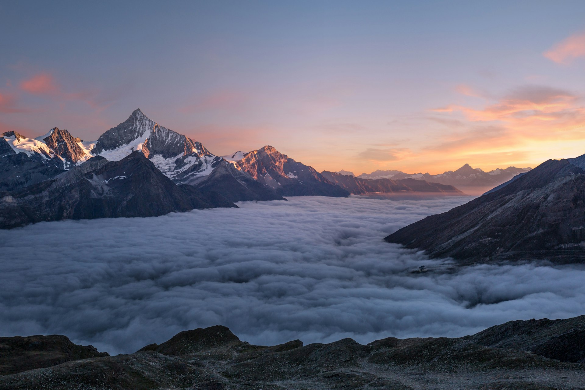 Snow-covered peaks above a sea of cloud